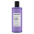 Purple shampoo bottle with black cap on a white background