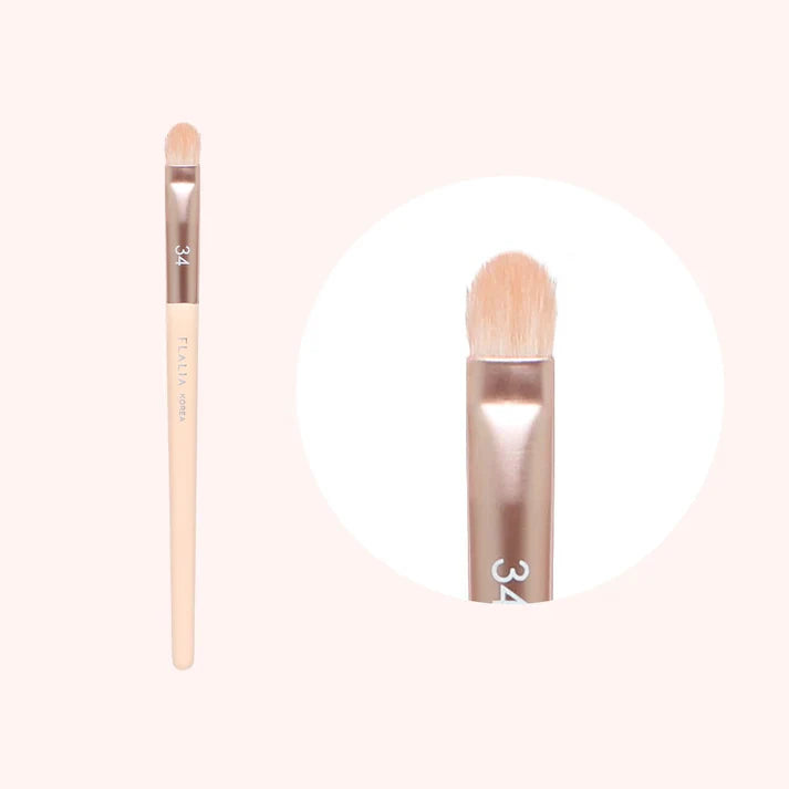 A makeup brush with a wooden handle and beige bristles, labeled with the number 32.