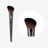 A makeup brush with a angled flat head, featuring a black handle and brown bristles, shown from two different angles.